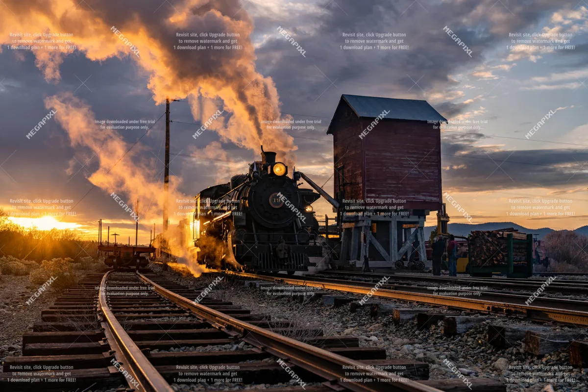 A classic steam locomotive sits beside a wooden water tower under a glowing sunset sky. The scene captures the historic charm and sense of adventure associated with train rides, evoking the Sumpter Valley Railway mentioned in the section.